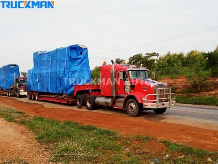 Low-bed trucks transporting railcars