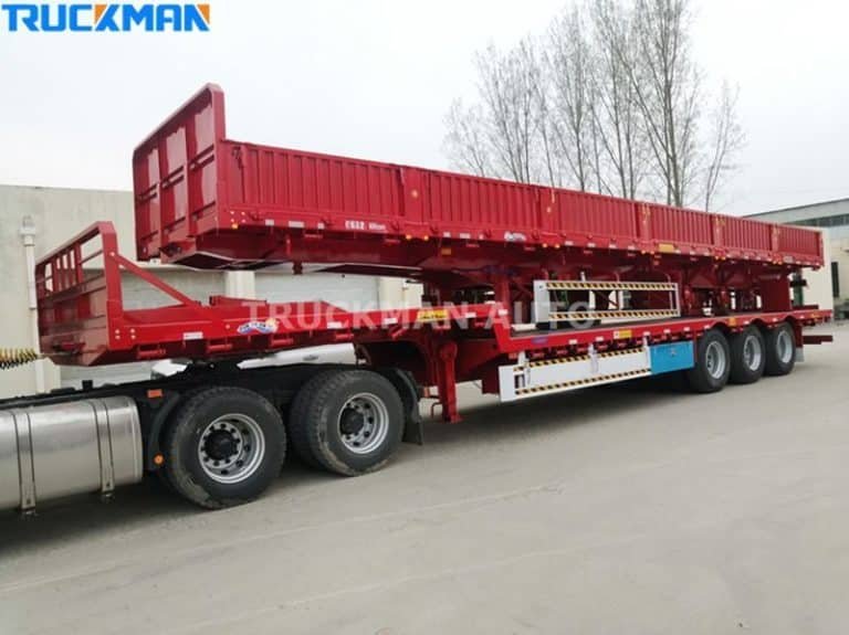 Red flatbed low-bed semi-trailer parked and ready for cargo loading