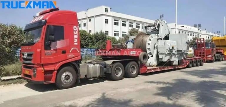 Red low-bed semi-trailer for transporting large construction machinery - high load capacity and stability