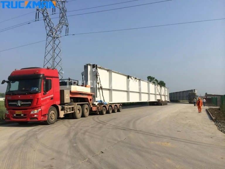 Extended low-bed semi-trailers haul extremely long and wide prefabricated structures with load size versatility.