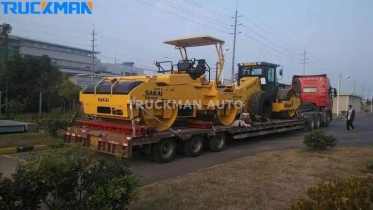 Low-chassis semi-trailer transporting a SAKAI road roller - Versatility in heavy machinery transport