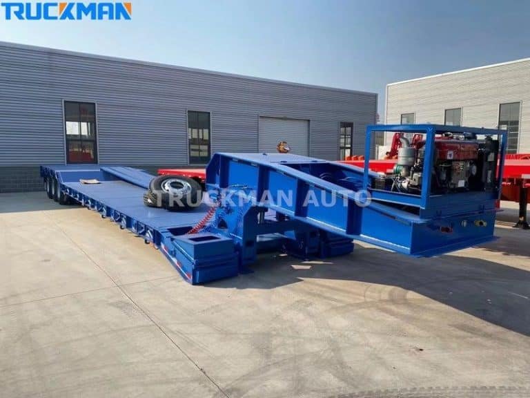 Blue low-bed semi-trailer showing off its spacious loading platform and neatly maintained condition, ready for use