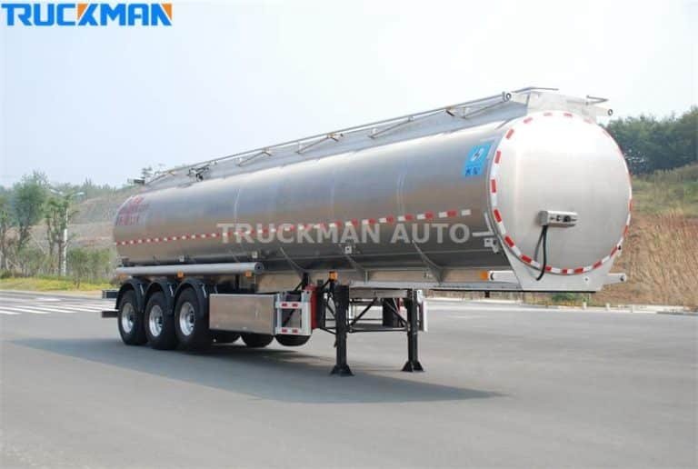 Polished aluminum powder cement tanker trailer on a testing track