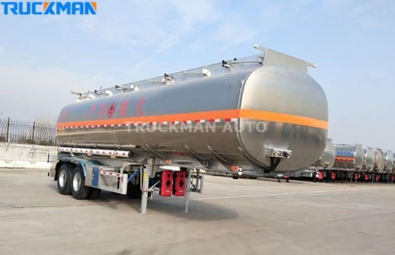 Side view of a TRUCKMAN AUTO aluminum alloy fuel tanker trailer with multiple safety labels and reinforced support legs.