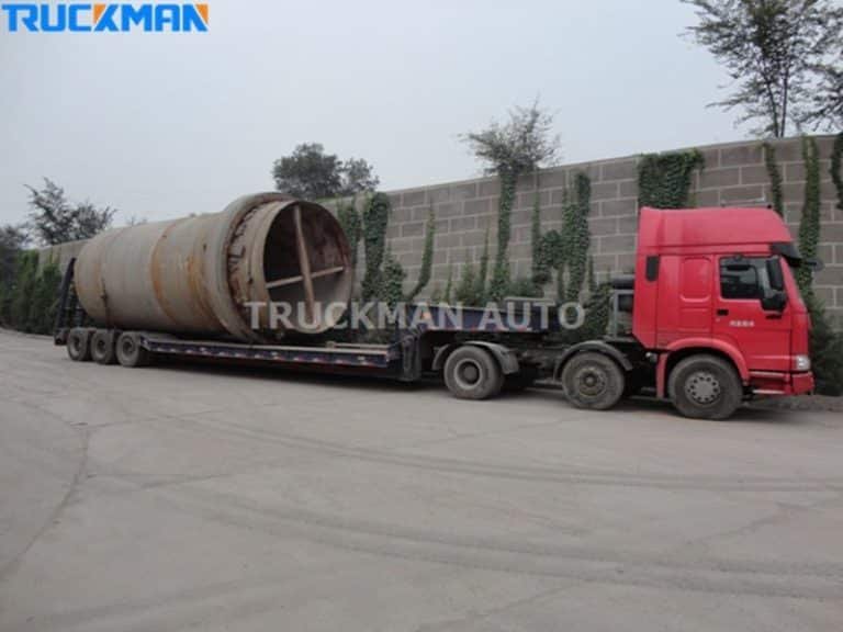 Low-bed semi-trailer carrying oversized industrial tanks, demonstrating the trailer's ability to transport oversized goods