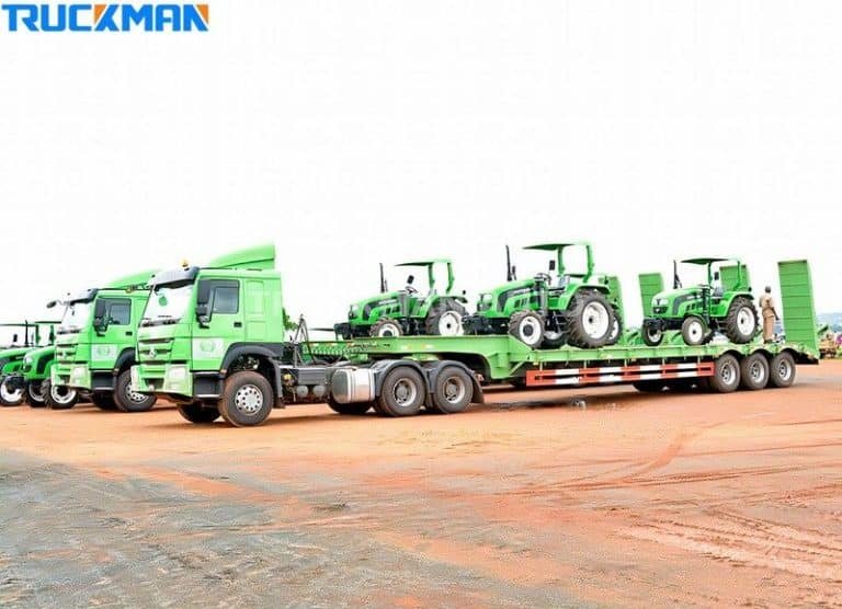 Fleet of low-bed semi-trailers with green tractors, efficient transport of a wide range of agricultural machinery