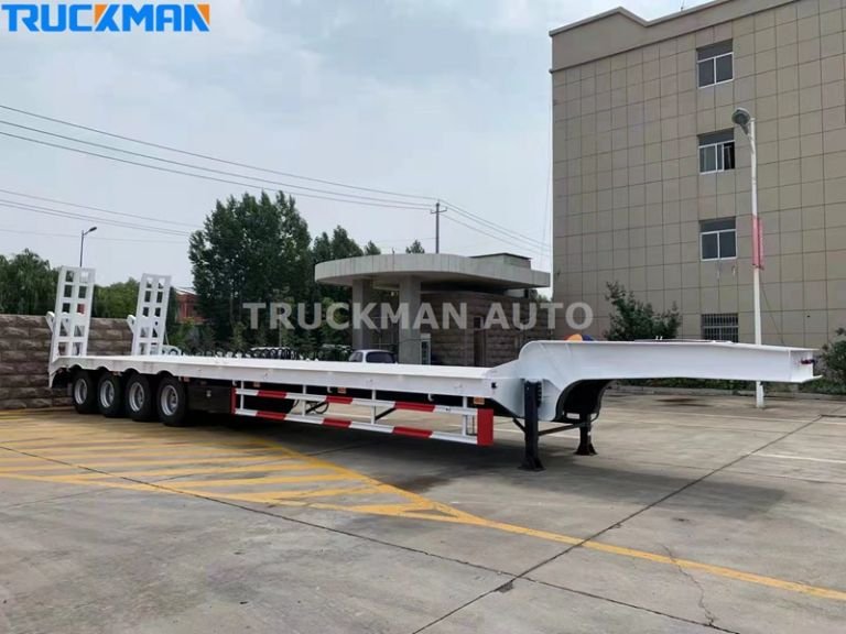 White flatbed semi trailer at a loading dock, showcasing the inspection of the loading ramp before loading